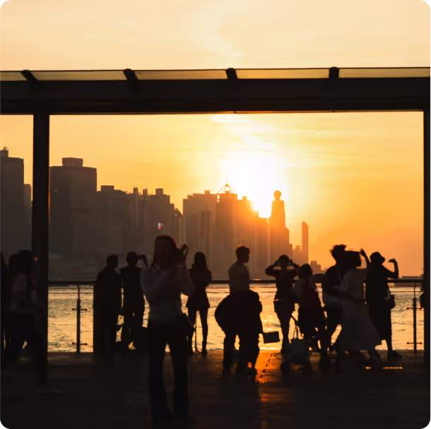 A group of people in front of the water in a city