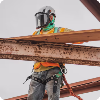 A construction worker surrounded with rails at a construction site
