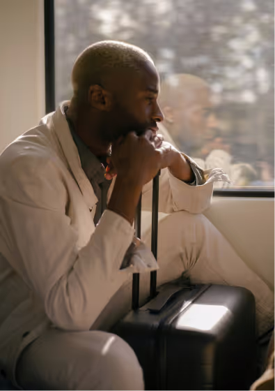 A person sitting and holding a luggage